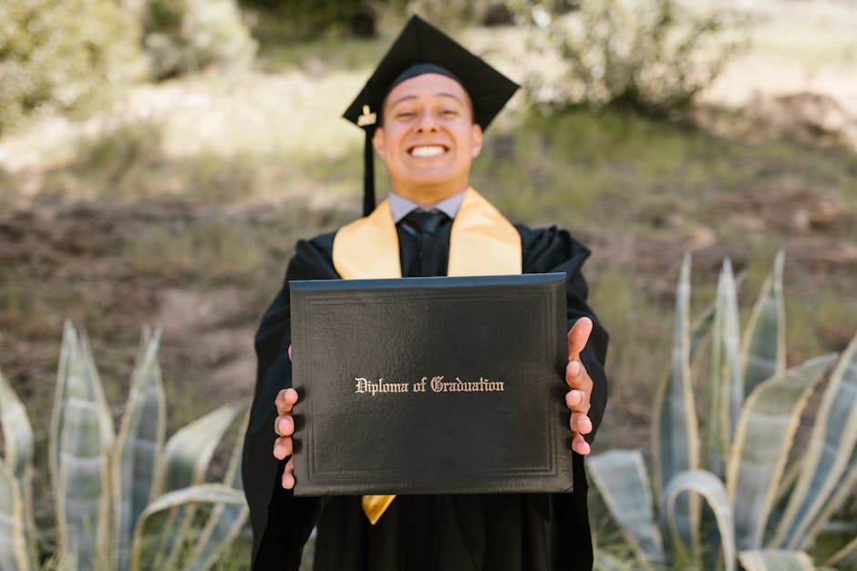 Graduate displaying diploma outdoors