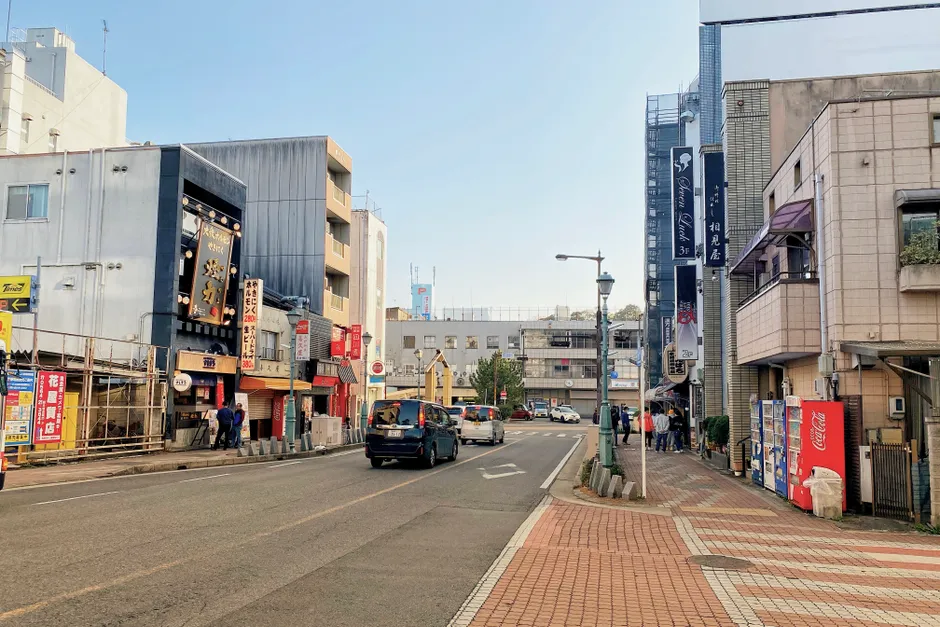 Explore the vibrant streets of Okazaki, Aichi, Japan with buildings, cars, and pedestrians.