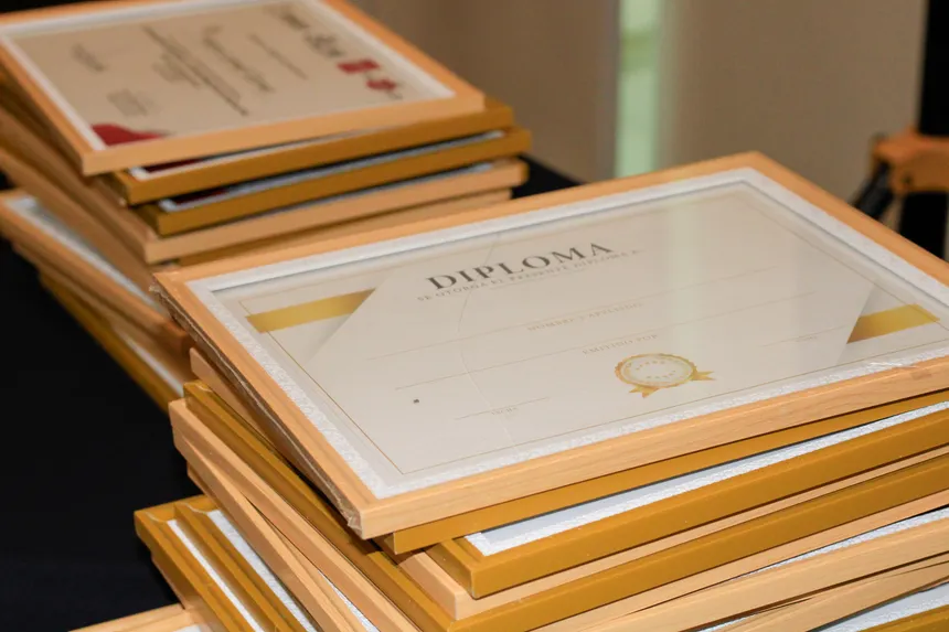 A stack of elegant framed diplomas prepared for an academic ceremony.